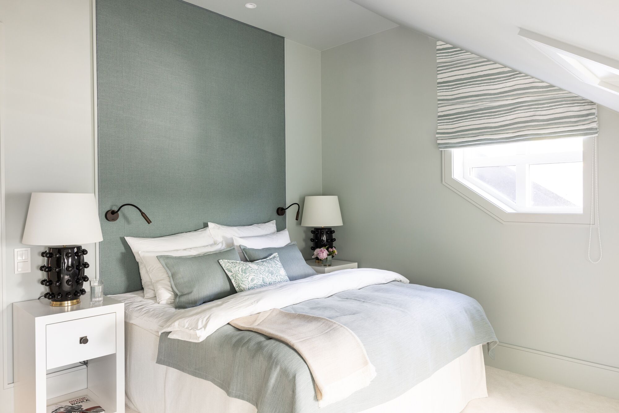 Bedroom with a sage upholstered wall