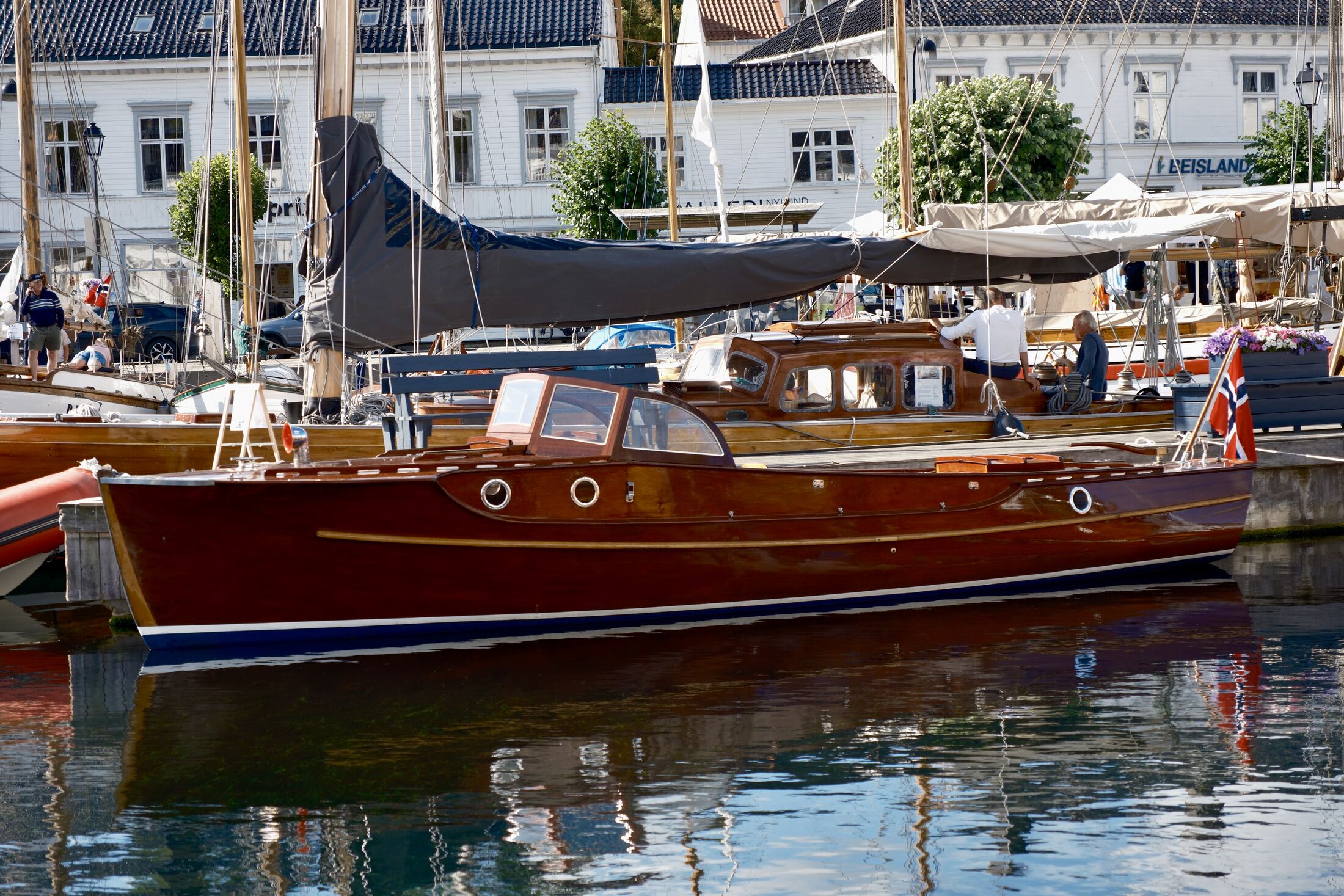A varnished mahogany launch moored at the quay during the wooden boat festival