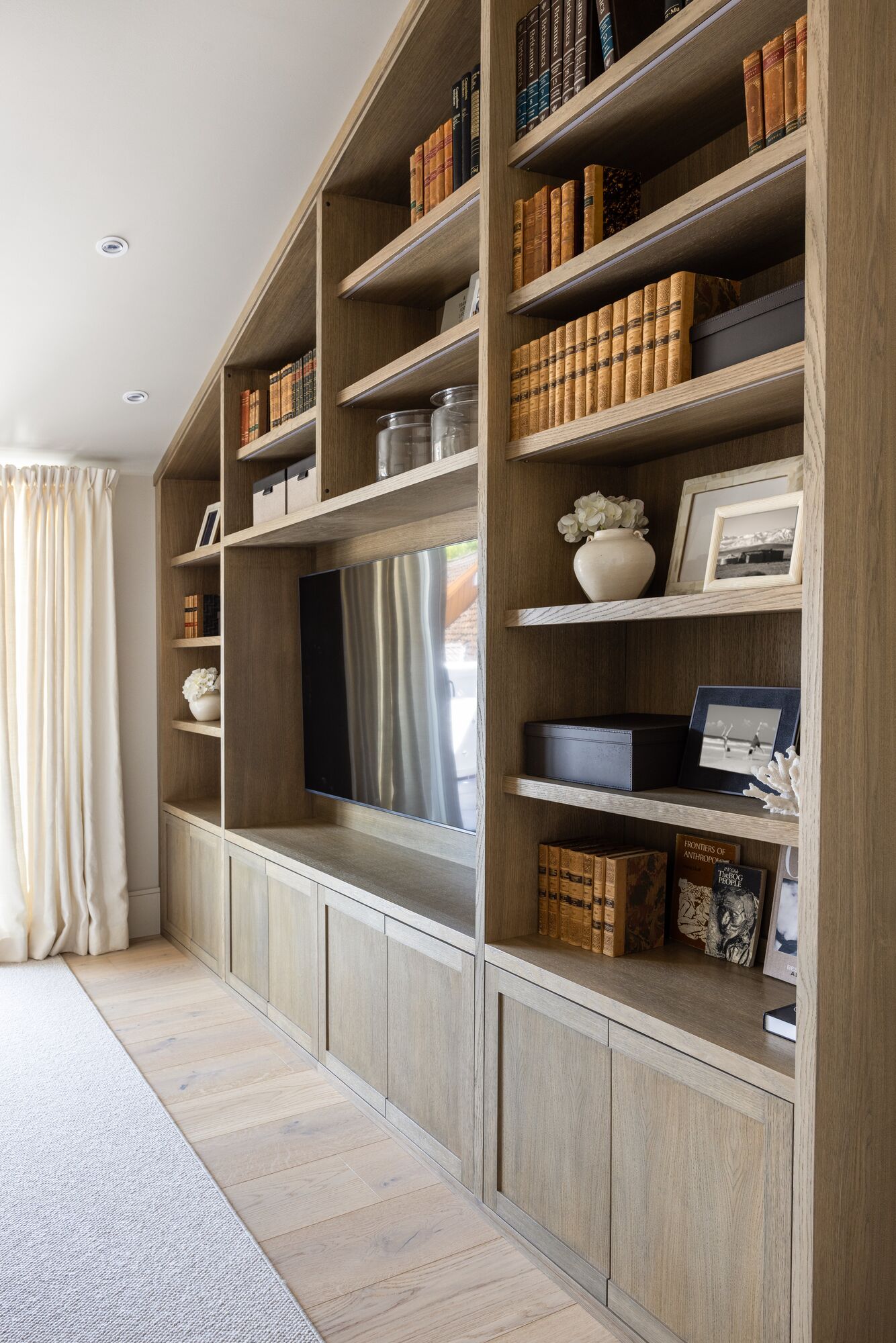 A built-in oak bookcase wall